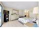 Well-lit bedroom with light-colored walls, tiled floors, and an ensuite bathroom at 144 Rotonda Cir, Rotonda West, FL 33947