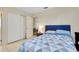 Comfortable bedroom featuring a bed with blue accents and a closet for storage at 144 Rotonda Cir, Rotonda West, FL 33947