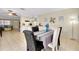 Inviting dining area with a view into the kitchen and living room creates an open concept living space at 144 Rotonda Cir, Rotonda West, FL 33947