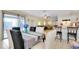 Open-concept dining area with a table for six and a view of the living room and kitchen at 144 Rotonda Cir, Rotonda West, FL 33947