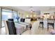 Open-concept dining area with a table for six and a view of the living room and kitchen at 144 Rotonda Cir, Rotonda West, FL 33947