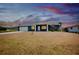 Beautiful single-story home featuring a well-manicured lawn, complemented by a serene evening sky at 144 Rotonda Cir, Rotonda West, FL 33947