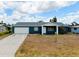 Charming single-story home featuring a well-maintained lawn, a driveway, and inviting curb appeal at 144 Rotonda Cir, Rotonda West, FL 33947
