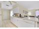 Kitchen featuring white appliances and cabinetry, connecting to the dining area for easy meal service at 144 Rotonda Cir, Rotonda West, FL 33947