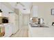 Well-maintained kitchen featuring white cabinets, appliances, and tile flooring for easy cleaning at 144 Rotonda Cir, Rotonda West, FL 33947