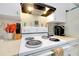 Kitchen with white range and range hood and decorative accents create a charming cooking space at 144 Rotonda Cir, Rotonda West, FL 33947