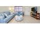 Comfortable living room featuring stylish sofas, a decorative ottoman, and tile flooring for easy maintenance at 144 Rotonda Cir, Rotonda West, FL 33947