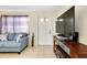 Cozy living area with natural light, complemented by comfortable seating and a large television at 144 Rotonda Cir, Rotonda West, FL 33947