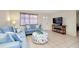 Inviting living room with comfortable seating, stylish ottoman, and large television for relaxing evenings at 144 Rotonda Cir, Rotonda West, FL 33947