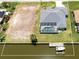 Aerial view highlighting the property's layout, pool, waterfront access, boat dock, and adjacent vacant lot at 15448 Avery Rd, Port Charlotte, FL 33981