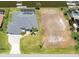 Aerial view of home with boat dock, pool, waterfront access, and adjacent lot at 15448 Avery Rd, Port Charlotte, FL 33981