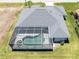 Aerial view of a home with a screened-in pool and spa, plus a boat dock for easy water access at 15448 Avery Rd, Port Charlotte, FL 33981