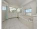 Bright bathroom with a large soaking tub, glass block shower, and a large vanity at 15448 Avery Rd, Port Charlotte, FL 33981