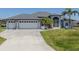 Lovely single Gathering home showcasing a manicured lawn and a three car garage at 15448 Avery Rd, Port Charlotte, FL 33981