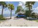 Beach scene with stacked kayaks for rent, set against a backdrop of palm trees and calm ocean waters at 15448 Avery Rd, Port Charlotte, FL 33981