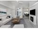 Well-lit living room with a fireplace, contemporary decor, and an open layout connecting to the dining area at 15448 Avery Rd, Port Charlotte, FL 33981