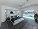 Bright main bedroom with pool views, large bed, and tasteful decor for a relaxing retreat at 15448 Avery Rd, Port Charlotte, FL 33981