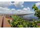 Picturesque view of a long wooden pier extending into the calm waters under a bright blue sky at 15448 Avery Rd, Port Charlotte, FL 33981