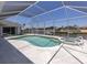 Beautiful screened pool with spa, perfect for outdoor relaxation and entertainment with waterfront views at 15448 Avery Rd, Port Charlotte, FL 33981