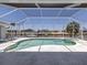 The screened-in pool area offers a jacuzzi and scenic water views, perfect for relaxation and entertainment at 15448 Avery Rd, Port Charlotte, FL 33981