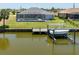 Stunning waterfront home with boat dock and lift, pool, and well-manicured lawn, perfect for boating enthusiasts at 15448 Avery Rd, Port Charlotte, FL 33981