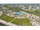 Aerial view of neighborhood tennis courts with professional surfacing in a beautiful, natural setting near the water at 1568 Ringtail Rd, Venice, FL 34293