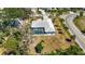 Aerial view of a home with an enclosed pool and a large backyard at 1568 Ringtail Rd, Venice, FL 34293
