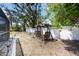 Wooden swing bench nestled in a backyard, enclosed by a white lattice fence at 1568 Ringtail Rd, Venice, FL 34293