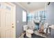 Cozy bathroom with a white door, decorative shower curtain, and tiled flooring at 1568 Ringtail Rd, Venice, FL 34293