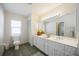 Bathroom featuring a double vanity, ample lighting, and neutral decor at 1568 Ringtail Rd, Venice, FL 34293