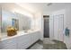 Bright bathroom with double sink vanity, walk-in shower and white cabinetry at 1568 Ringtail Rd, Venice, FL 34293