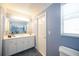Stylish bathroom with a spacious vanity, ample lighting, and a well-placed window for natural light at 1568 Ringtail Rd, Venice, FL 34293