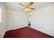Bedroom with a ceiling fan and closet for storage, featuring red carpet flooring at 1568 Ringtail Rd, Venice, FL 34293