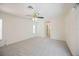 Neutral bedroom featuring a fan, carpet and entrance to the bathroom hallway at 1568 Ringtail Rd, Venice, FL 34293
