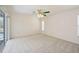 Carpeted bedroom featuring a sliding glass door and fan with lights at 1568 Ringtail Rd, Venice, FL 34293