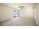 Bright bedroom featuring new carpet and sliding doors leading to outdoor space at 1568 Ringtail Rd, Venice, FL 34293