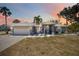 Charming single-story home showcasing a three-car garage, tile roof and landscaped yard at 1568 Ringtail Rd, Venice, FL 34293