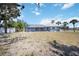 Exterior backyard view of a charming screened-in pool and lush lawn at 1568 Ringtail Rd, Venice, FL 34293