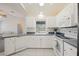 Bright white kitchen featuring matching appliances, tile backsplash, and window over the sink at 1568 Ringtail Rd, Venice, FL 34293