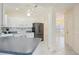 Open kitchen showcasing white cabinets, stainless steel appliances, and a seamless transition to the dining area at 1568 Ringtail Rd, Venice, FL 34293