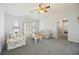 Bright living room with ceiling fan, comfortable seating, and backyard access at 1568 Ringtail Rd, Venice, FL 34293