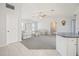 Inviting living room with plush carpeting, a cozy seating arrangement, and a partial view of the open-concept kitchen at 1568 Ringtail Rd, Venice, FL 34293