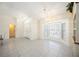 Bright living space showcasing tile floors, a large bay window, and a convenient entrance to the side of the house at 1568 Ringtail Rd, Venice, FL 34293