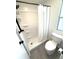 Bright bathroom featuring a walk-in shower with black fixtures and a toilet with a modern design at 177 Palm Harbor Dr, North Port, FL 34287