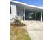 Home boasts a spacious carport with ample parking and a beautifully landscaped entryway at 177 Palm Harbor Dr, North Port, FL 34287