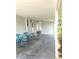 The covered carport area features space for seating and entry to the house at 177 Palm Harbor Dr, North Port, FL 34287