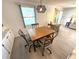 Dining room with a wooden table, unique light fixture, and seating for four at 177 Palm Harbor Dr, North Port, FL 34287