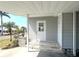 Covered porch area showcases steps to the entry door and views of a well landscaped yard at 177 Palm Harbor Dr, North Port, FL 34287