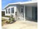Exterior view of the home featuring a covered carport and beautifully landscaped entryway with colorful plants at 177 Palm Harbor Dr, North Port, FL 34287