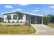 Charming home featuring well-manicured landscaping, a covered carport, and lovely curb appeal at 177 Palm Harbor Dr, North Port, FL 34287